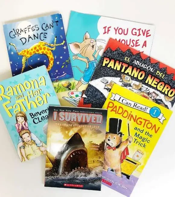 A colorful collection of children's books arranged on a white surface, showcasing various titles and illustrations.